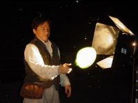 Jackie swats at insects using an electric bug swatting paddle.