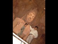 In front of the Buddha.