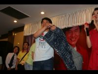 Jackie removes his autographed jacket. His entire outfit pulled in nearly US$38,000 for the charity.