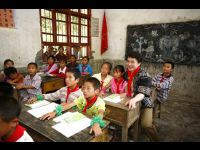 Jackie attends class with students at the old school building.