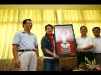 Jackie receives a gift from local government officials.