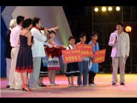 Handing out scholarships and supplies to several students on behalf of Dragon's Heart Foundation.