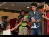 A little boy makes a donation at the Dragon's Heart Charity Auction. The two-hour auction generated over US$125,000.
