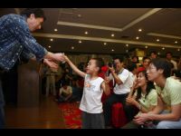 A little boy offers Jackie his donation of 10 RMB.
