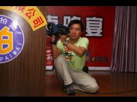 Videographer Xavier Lee records the charity auction.