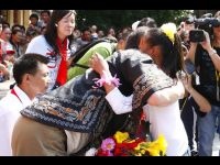 Jackie comforts the young girl with a hug.