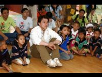 Jackie and the children watch a video together.