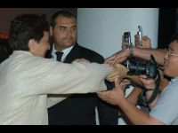 Security keeps a close eye on Jackie as fans try to pull him away!