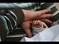 Jackie compares the size of his hand to Matthew's.