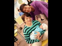 Jackie and Louis with a sleeping Matthew.