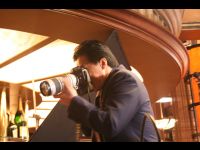 Jackie is taking a photo of Brett Ratner, who is fast asleep on the set.