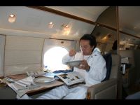 Eating dinner and relaxing on the airplane.