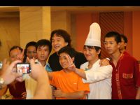 Jackie stops in the hallway to take photos with hotel staff.