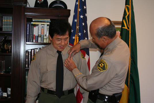 Jackie watches cautiously as the officer pins a badge on him. (Remember, Jackie's afraid of needles!)