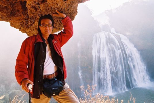 Ken Lo under the waterfall.