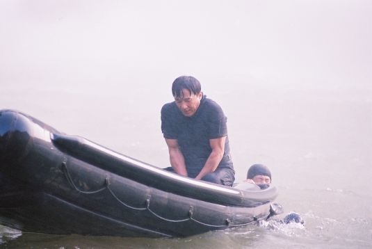 Freezing cold Jackie waits in the rowboat during filming of the waterfall scenes.
