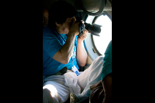 Jackie taking the photos out the helicopter window.