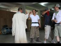 Jackie, Jet, and Woo Ping plan an action sequence.