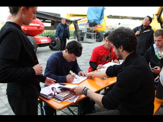 Signing photos and books for fans.