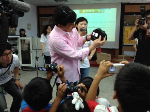 Jackie demonstrates how to use his camera.